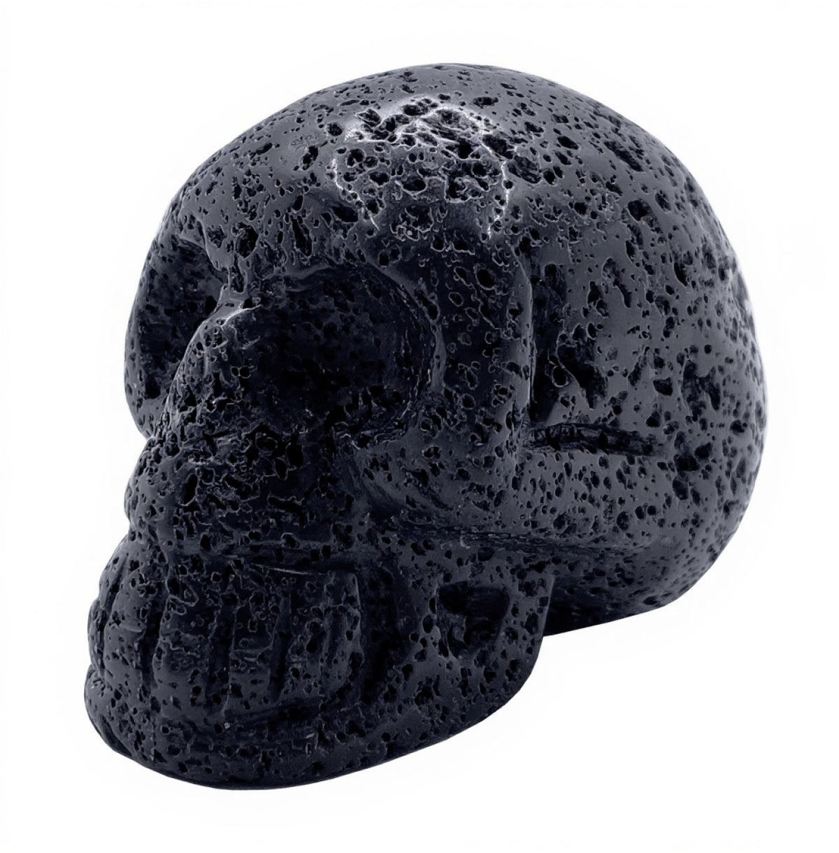 angled view of carved black lava stone skull showing porous volcanic texture